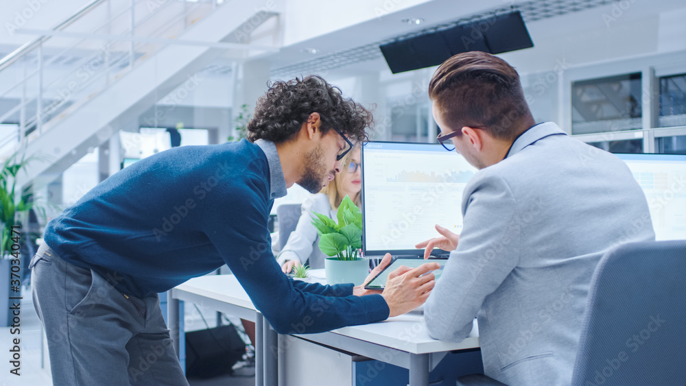 Aufkleber In Bright Modern Office: Office Worker Sitting and Working at His Desktop Computer, Discusses Problem Solution with His Project Manager and Team Leader. Young Businessmen Planning and Problem Solving