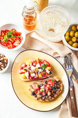 Delicious bruschettas with mushrooms, blue cheese, olives and tomatoes