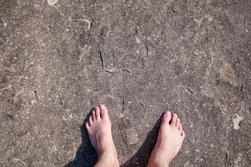The feet of a man standing on the rocks