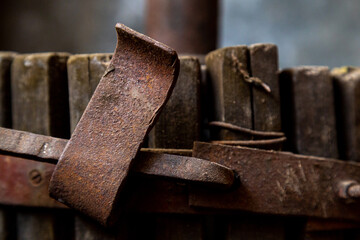 Wine pressing machine old rusty detail, close-up industrial background, Detail of wooden wine press for pressing grapes to produce wine. Traditional old technique of home wine-making 