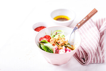 Fresh salad with couscous, tomatoes, cucumber, radish and chard.