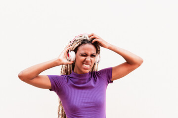 Obraz na płótnie Canvas African girl moving blond dreadlocks hair wearing while listening music playlist with headphones - Youth lifestyle and trendy people concept - Focus on face