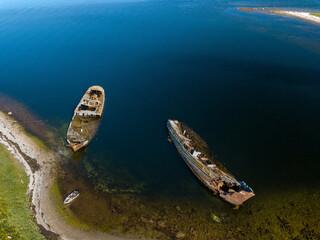 Aerial view of abandoned and derelict rusty old ships near lonaly island in The Arctic Ocean....