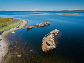 Aerial view of abandoned and derelict rusty old ships near lonaly island in The Arctic Ocean....
