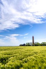 The beautiful Lighthouse Of Flügge On The Isle Of Fehmarn at the Baltic Sea in Germany. Summer in...