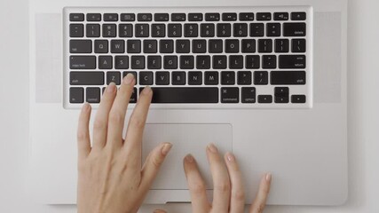 Woman uses a touch pad on a laptop computer or notebook then typing on keyboard. Modern computer with wireless technology