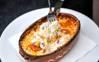Oven baked cheese in a ceramic baking dish.