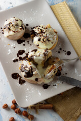 original cinnabon rolls with chocolate-cream sauce and hazelnuts