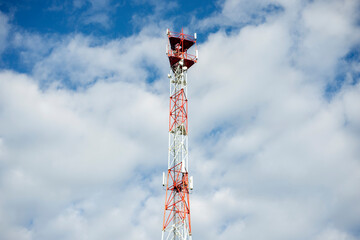 Obraz premium Telecommunication tower with blue sky and white clouds. Antenna on blue sky. Communication technology. Mobile or telecom 5g network. Technology