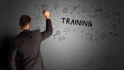businessman drawing a creative idea sketch with TRAINING inscription, business strategy concept