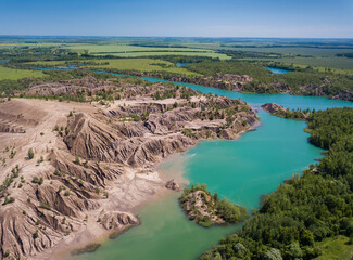 Obraz premium Fancy and unusual aerial landscape of Romantsev mountains wih blue lakes and mud erosion looks like alien surface of Mars.