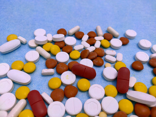 medicine pill and tablets spread on paper used in treatment of ill patients.