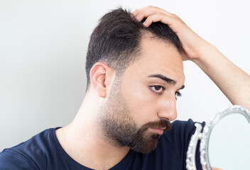 Obraz premium Portrait of a man worried about hair loss