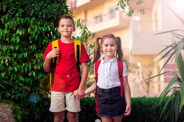 Back to school. Pupils with backpacks ready to school staying outdoor