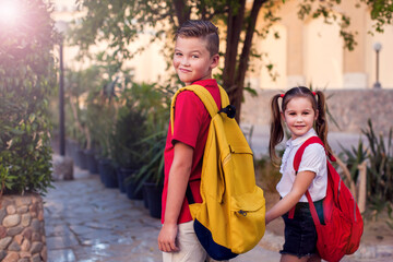 Back to school. Pupils with backpacks ready to school staying outdoor