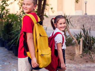 Back to school. Pupils with backpacks ready to school staying outdoor