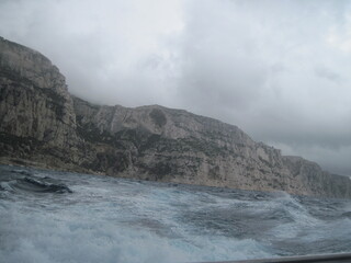 Panoramic view of Mediterranean Sea in storm. Beautiful power blue and white waves on a rainy day.