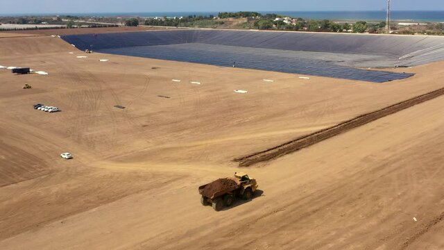 Water reservoir construction site with newly installed plastic lining sheets, Aerial view.