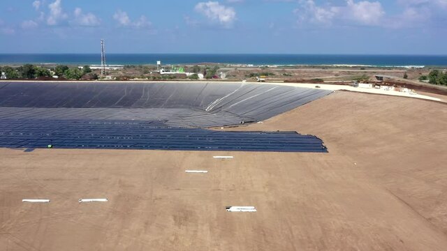 Water reservoir construction site with newly installed plastic lining sheets, Aerial view.