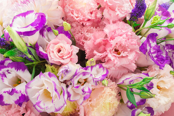 Pink and purple bouquet of flowers in a pink box isolated on white.