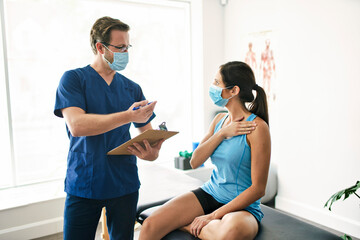 Male Physical Therapist Stretching a Female Patient Slowly.