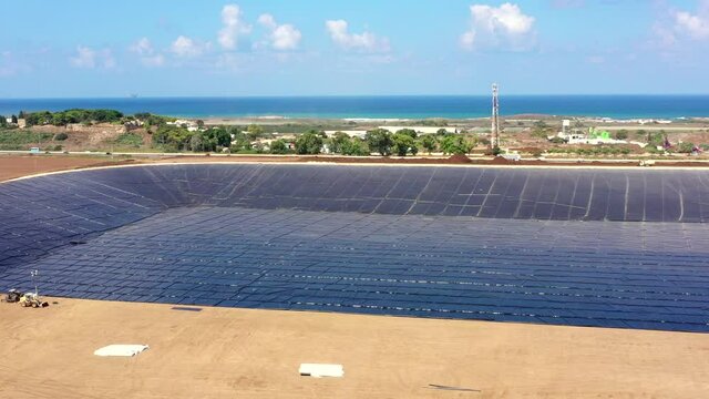 Water reservoir construction site with newly installed plastic lining sheets, Aerial view.