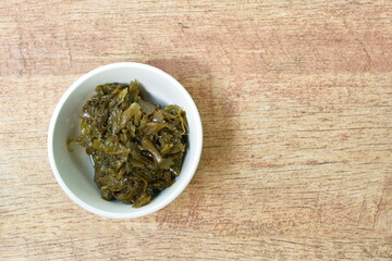 stir fried pickled mustard or Gan Lan Cai Chinese vegetarian food made from cabbage and black olive in oil on cup