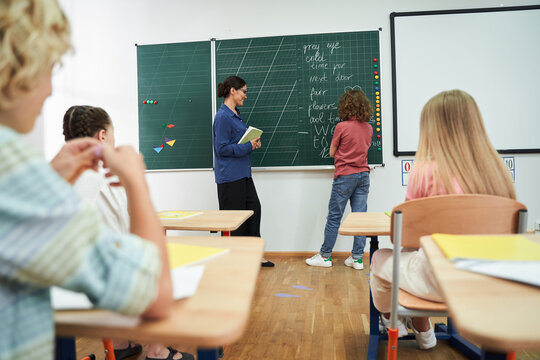 Pupils and tutor during english lesson at school