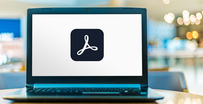 Laptop computer displaying logo of Adobe Acrobat