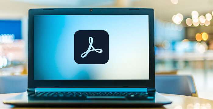 Laptop computer displaying logo of Adobe Acrobat