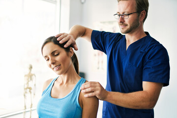 Male Physical Therapist Stretching a Female Patient nack