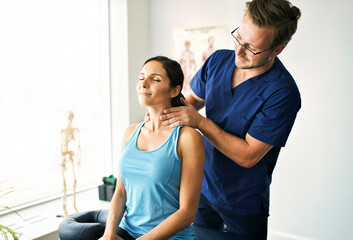Male Physical Therapist Stretching a Female Patient nack