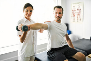 physiotherapist doing treatment with patient in bright office