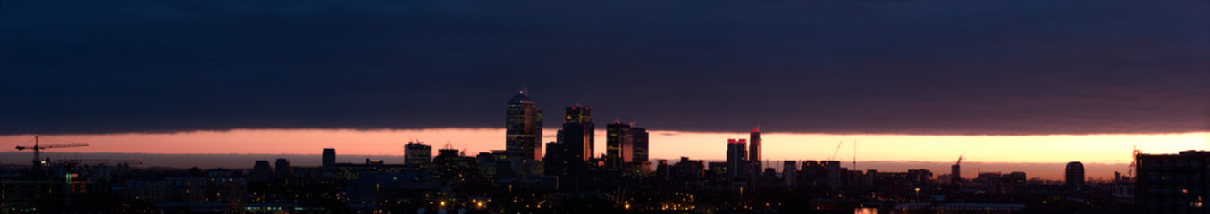 Colourful London Dawn under dissipating ominous cloud, Panorama.