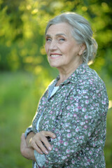 Portrait of senior beautiful woman posing in park