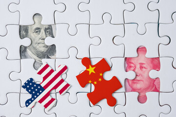 USA and China flag print screen on jigsaw puzzle which open and see Benjamin Franklin face and Mao...