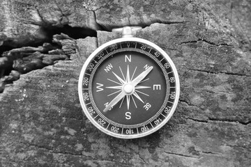 round compass on wooden background as symbol of tourism with compass, travel with compass and outdoor activities with compass