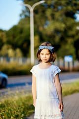 cute girl pose on the city street at sunset 