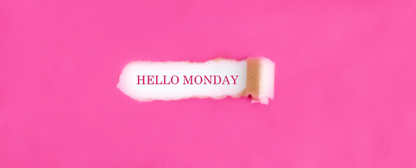 The text HELLO MONDAY appearing behind torn pink paper.