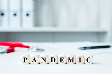 word pandemic on wooden blocks in a doctor's office