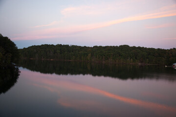 Fototapeta na wymiar Sunrise over a lake and reflecting it