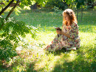 the girl is resting sitting on the ground in the Park