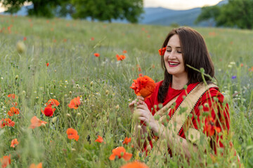 Yound girl dressed in Indian Sari in a poppy flower garden