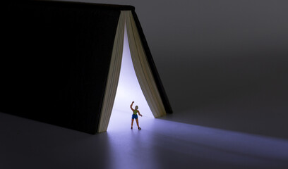 Glowing book and people opened in the night
