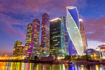 Moscow-city skyline panorama at night with colorful lights reflections on the surface of the river Moskva. Modern skyscrapers for business and life