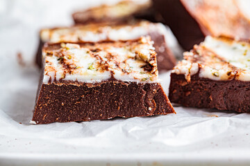Raw vegan chocolate bars with nuts and seeds, top view. Healthy sugar-free dessert.