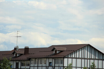 icon roof with new brown roofing tiles on residential property. banner on  roof for roofers....