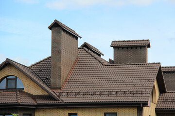 icon roof with new brown roofing tiles on residential property. banner on  roof for roofers....