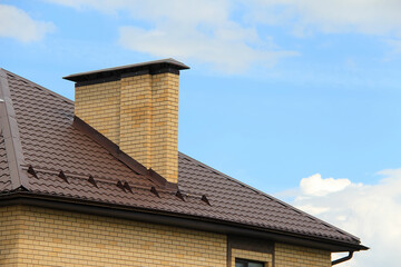 icon roof with new brown roofing tiles on residential property. banner on  roof for roofers....