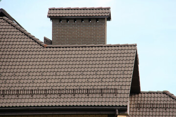 icon roof with new brown roofing tiles on residential property. banner on  roof for roofers....